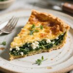 Gluten free spinach feta quiche slice on plate