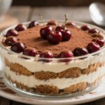 Cherry Amaretto Tiramisu in a glass dish with cocoa topping